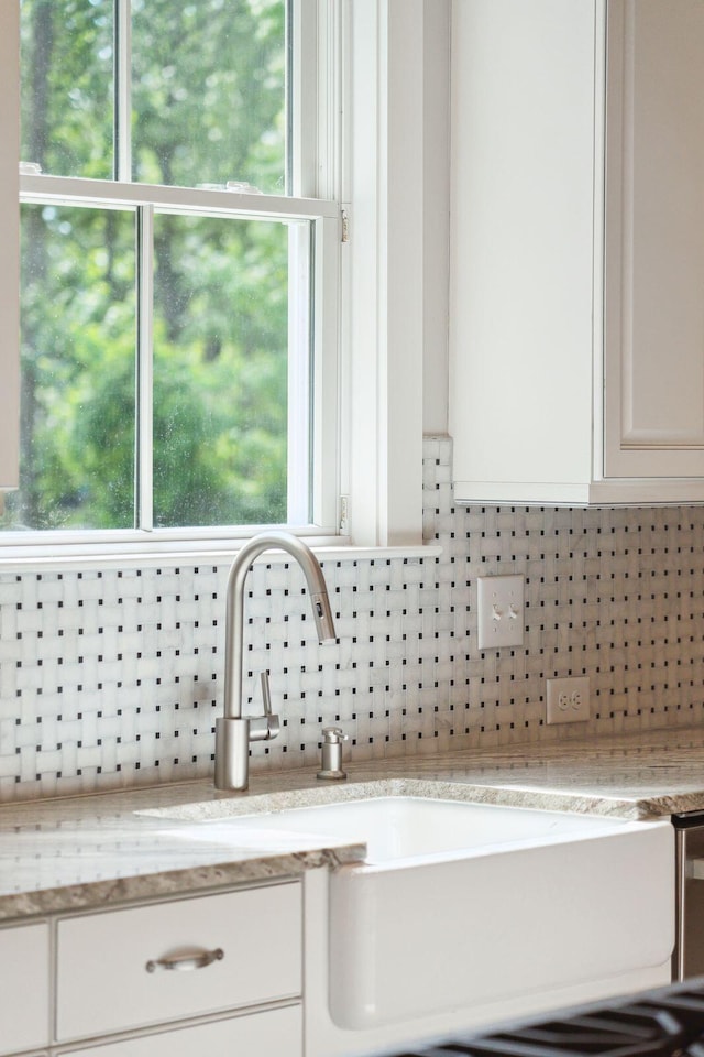 kitchen view of decorative backsplash and white cabinets