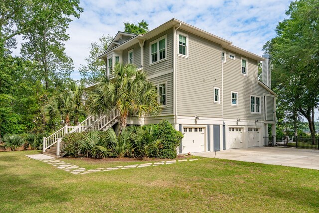 view of property exterior with an attached garage, stairway, concrete driveway, and a chimney