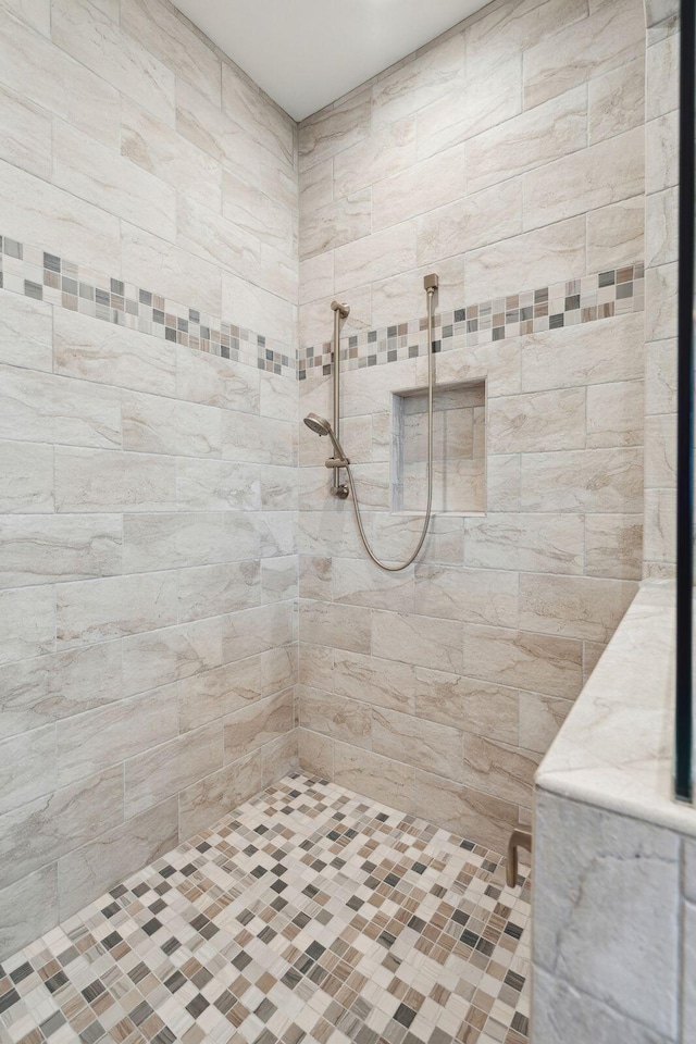 full bath with a tile shower