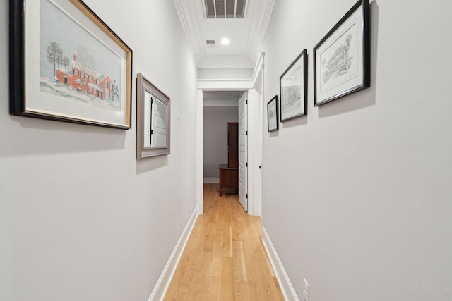 hallway featuring crown molding, light wood-style flooring, baseboards, and recessed lighting