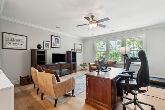 home office with light wood-type flooring, ceiling fan, ornamental molding, and baseboards