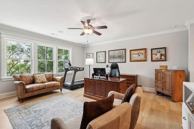 office featuring a ceiling fan, light wood-style flooring, baseboards, and crown molding
