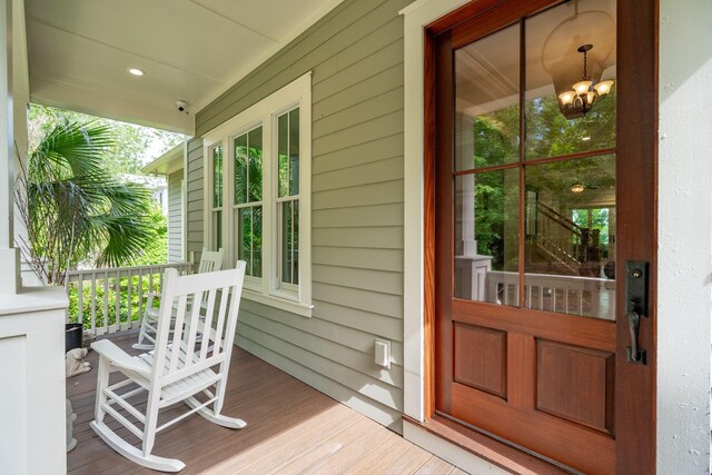 view of exterior entry with a porch and a surveillance system