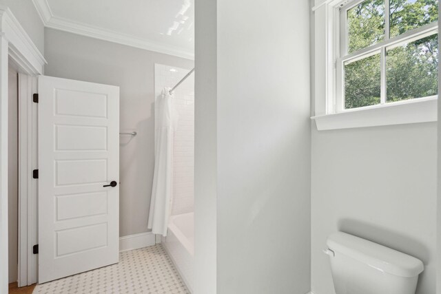 bathroom with tile patterned floors, ornamental molding, toilet, shower / tub combo, and baseboards