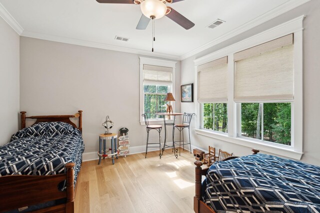 bedroom featuring wood finished floors, ornamental molding, baseboards, and ceiling fan