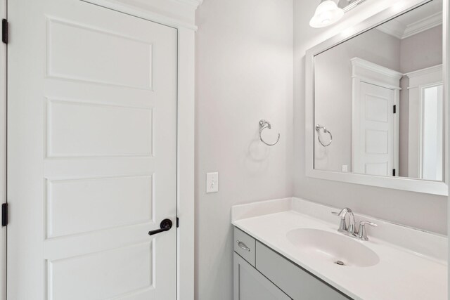 bathroom featuring ornamental molding and vanity