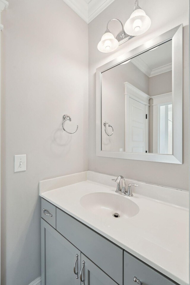 bathroom featuring crown molding and vanity