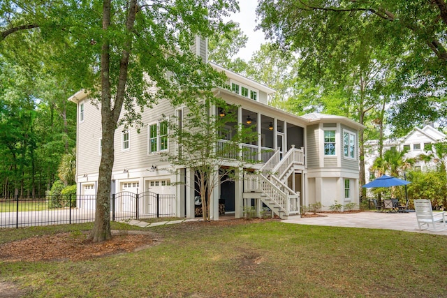 view of front facade featuring a ceiling fan, stairway, an attached garage, a chimney, and a patio area
