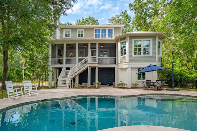 rear view of property featuring a ceiling fan, stairway, fence, and a patio area