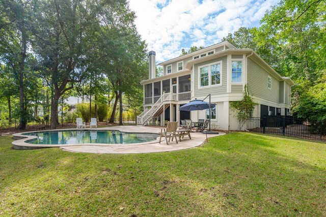 rear view of house featuring a sunroom, a patio, an outdoor pool, stairway, and a chimney