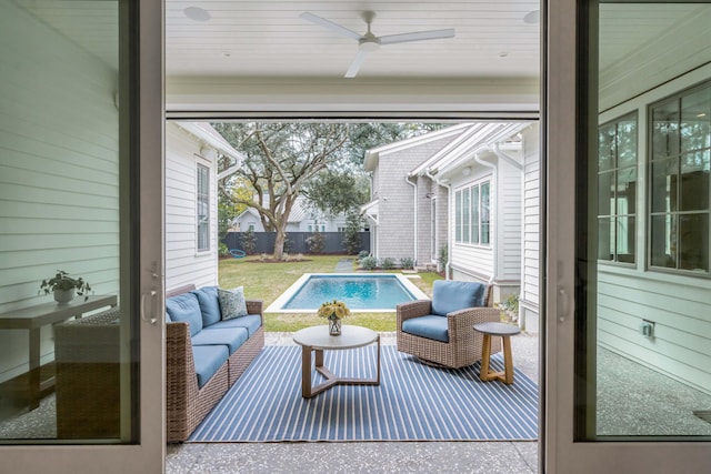 sunroom featuring ceiling fan