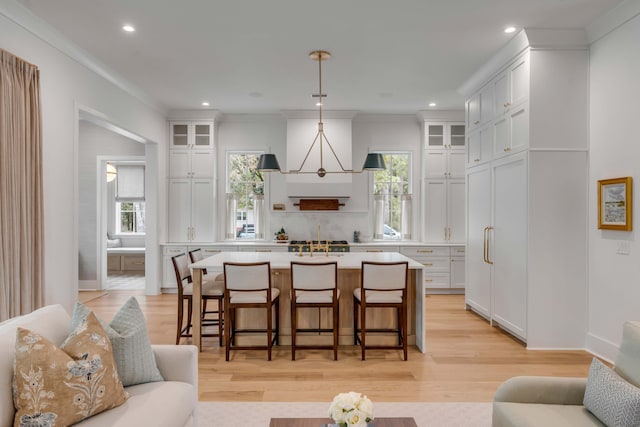 kitchen featuring pendant lighting, white cabinetry, and a center island