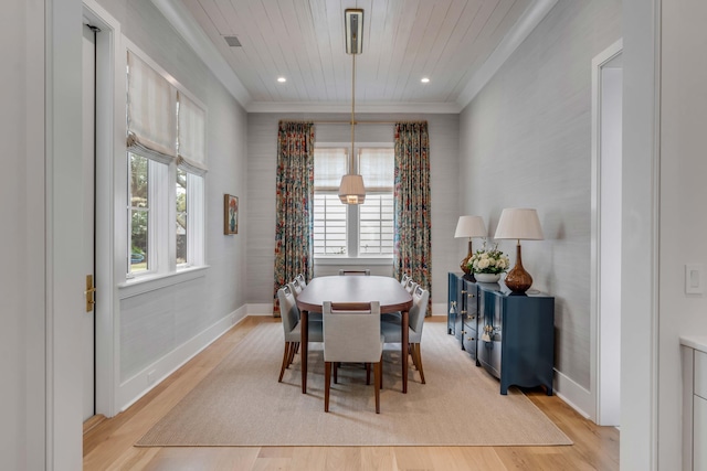 dining area featuring ornamental molding, wooden ceiling, and light wood-type flooring