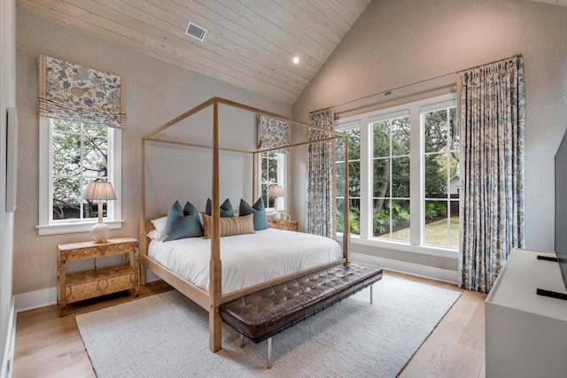 bedroom with wooden ceiling, high vaulted ceiling, and light hardwood / wood-style flooring