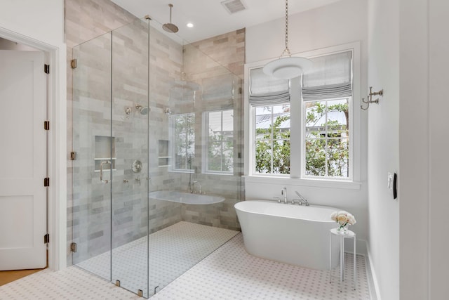 bathroom featuring independent shower and bath and tile patterned flooring