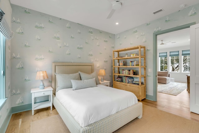 bedroom with ceiling fan and light hardwood / wood-style floors