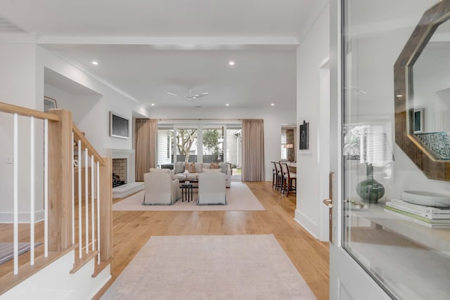 living room featuring ornamental molding and light wood-type flooring