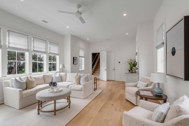 living room featuring ceiling fan and light hardwood / wood-style floors