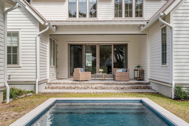 back of property with outdoor lounge area and a patio