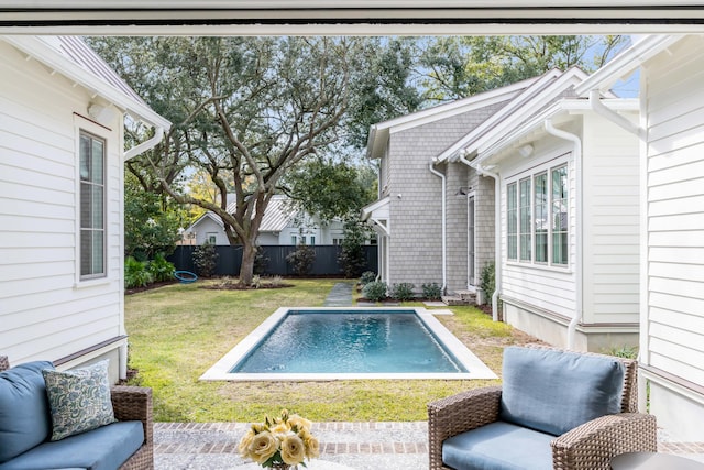 view of pool with a yard