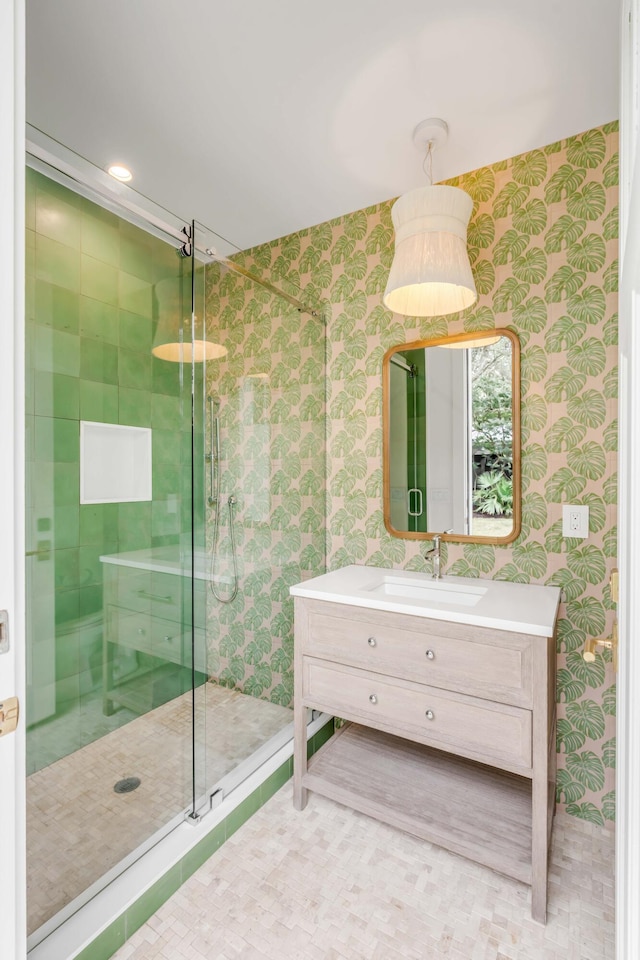 bathroom featuring walk in shower and vanity