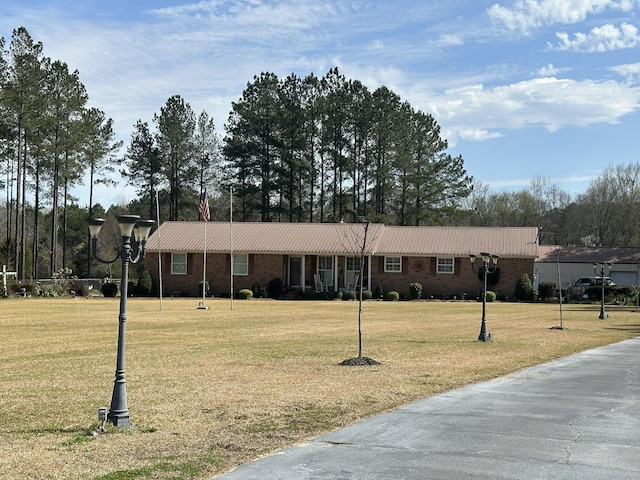 ranch-style home with brick siding and a front lawn