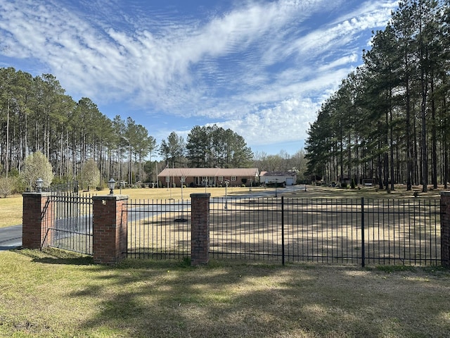 exterior space featuring a lawn and fence