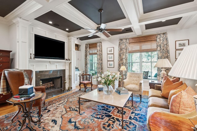 living room featuring ornamental molding, beamed ceiling, a fireplace, and a healthy amount of sunlight