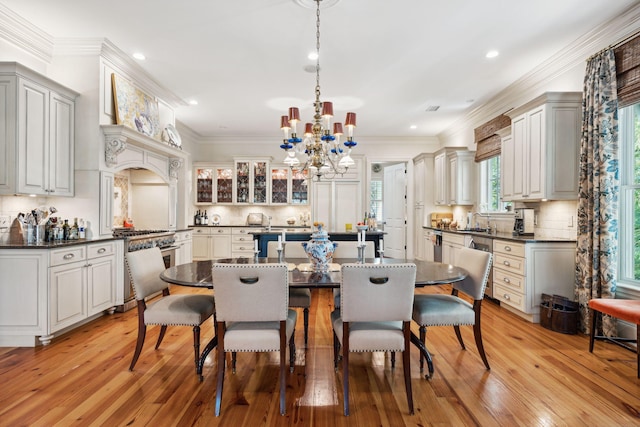 dining room with light wood-type flooring, a notable chandelier, crown molding, and recessed lighting