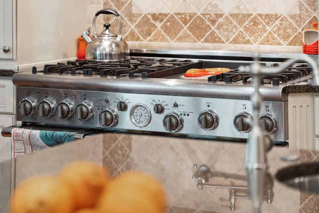 room details featuring dark countertops and decorative backsplash