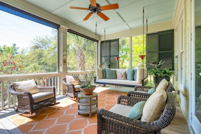 sunroom / solarium featuring ceiling fan