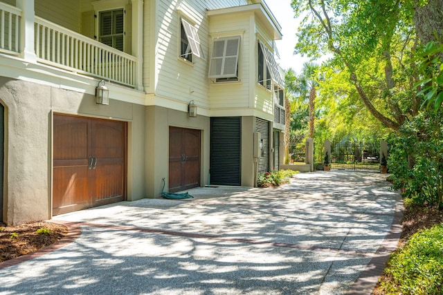 view of side of property with an attached garage and stucco siding