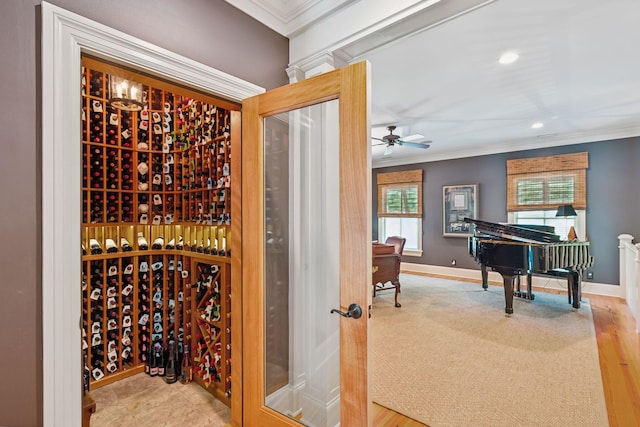 wine area with baseboards, crown molding, and recessed lighting