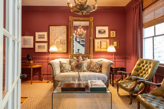 living area with a wainscoted wall, a chandelier, a decorative wall, and crown molding