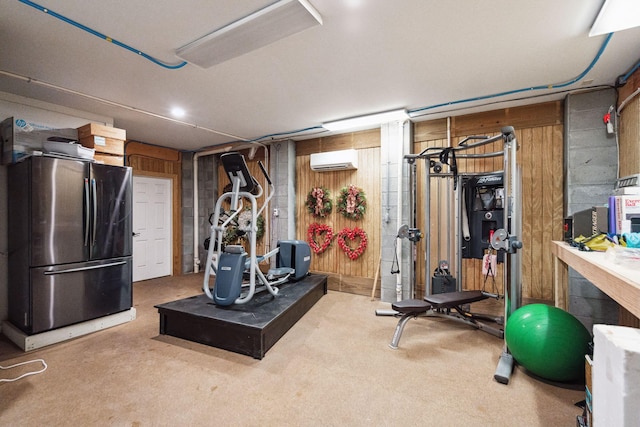 workout room featuring a wall unit AC, wood walls, and carpet floors