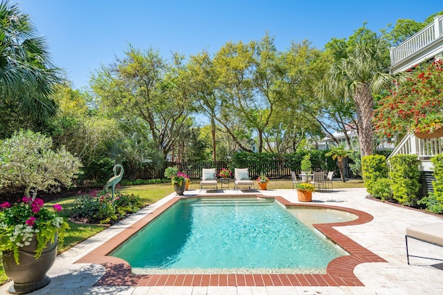 view of swimming pool with a patio area, fence, and a fenced in pool