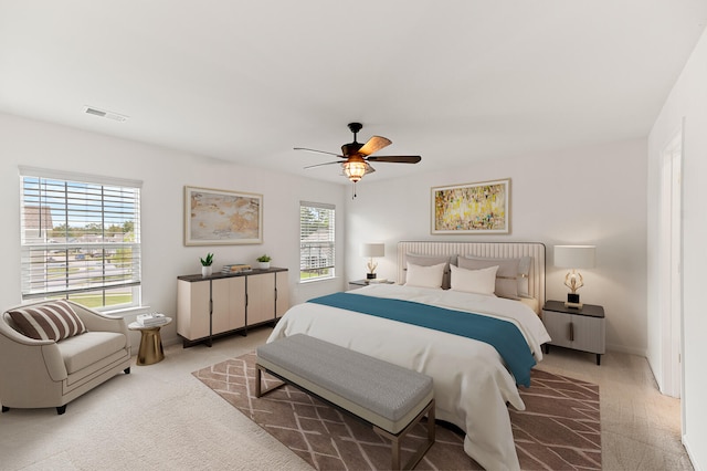 bedroom featuring light carpet and ceiling fan