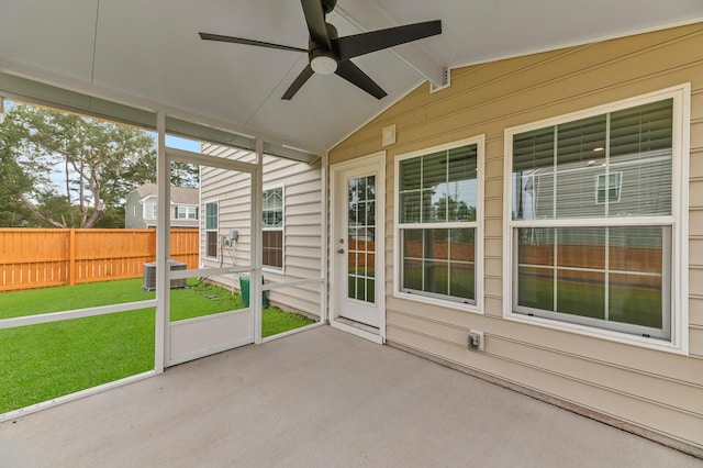 unfurnished sunroom featuring ceiling fan and lofted ceiling with beams