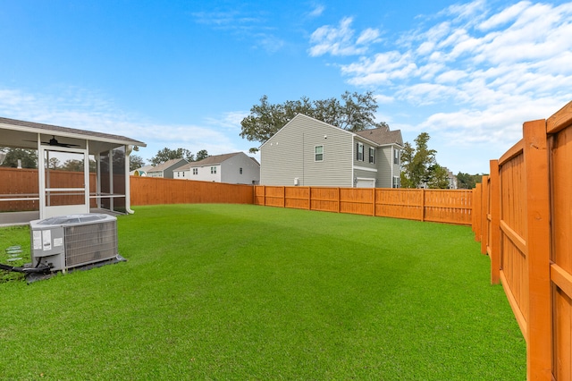 view of yard featuring cooling unit and a sunroom