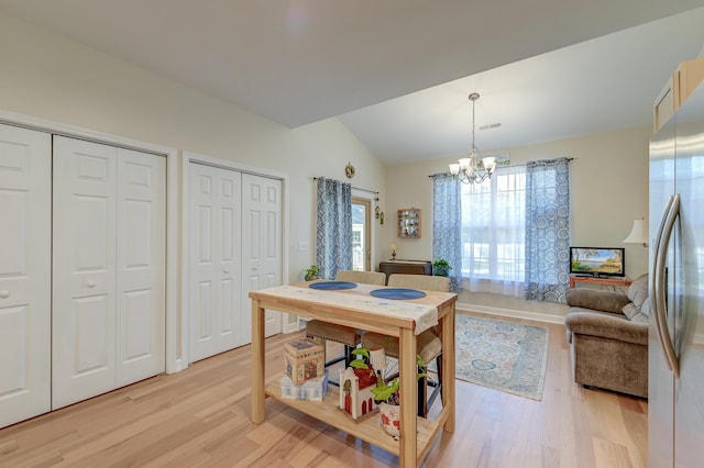 8965 N Red Maple Cir, Summerville, SC 29485 - dining area featuring a chandelier, light wood-style flooring, and vaulted ceiling