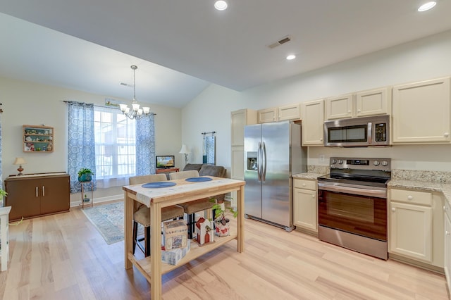 8965 N Red Maple Cir, Summerville, SC 29485 - kitchen with stainless steel appliances, light wood-style floors, lofted ceiling, a chandelier, and hanging light fixtures