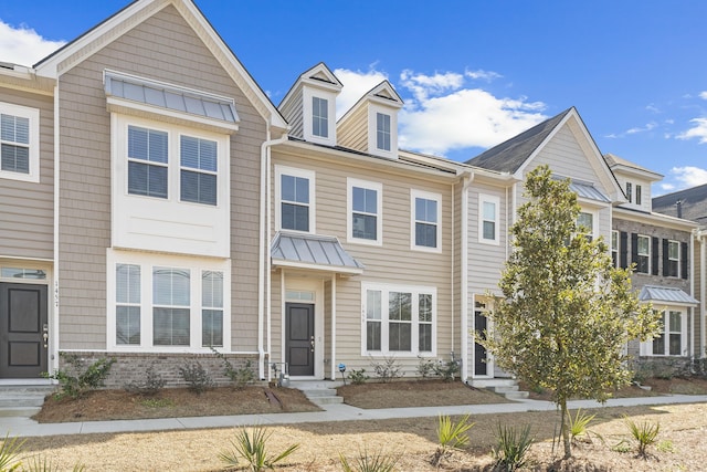 townhome / multi-family property featuring metal roof and a standing seam roof