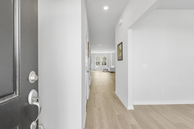 hallway with recessed lighting, light wood-style flooring, and baseboards