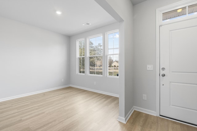 entrance foyer with light wood-type flooring, visible vents, and baseboards