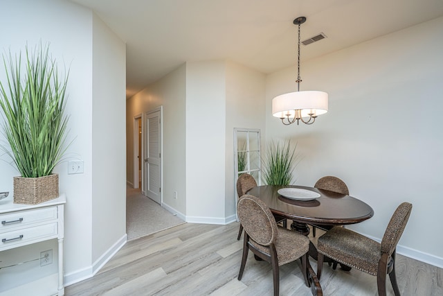 401 S Elgin Ct Unit 401, Charleston, SC 29414 - dining room featuring light wood-style floors, baseboards, and a chandelier