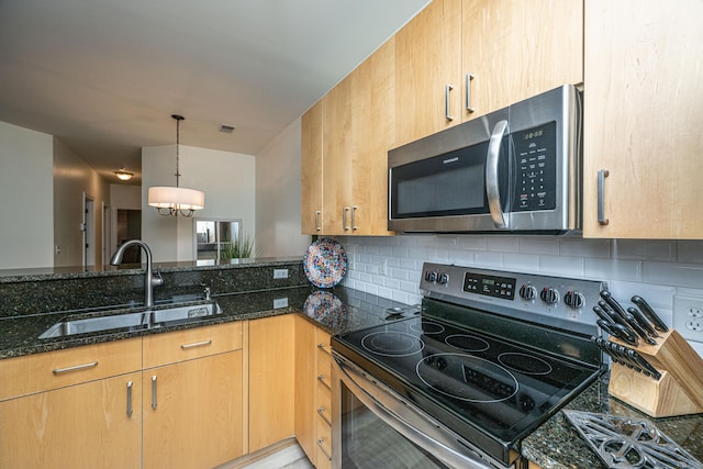 401 S Elgin Ct Unit 401, Charleston, SC 29414 - kitchen with appliances with stainless steel finishes, a sink, dark stone counters, backsplash, and a chandelier