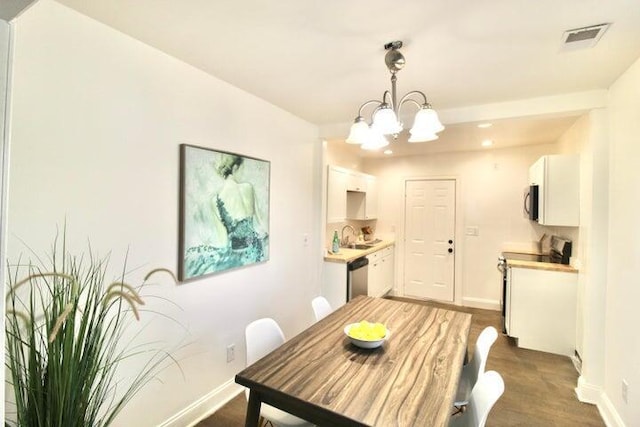 dining area featuring a chandelier and dark wood-type flooring