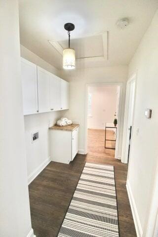 washroom with cabinets, dark hardwood / wood-style floors, and hookup for an electric dryer