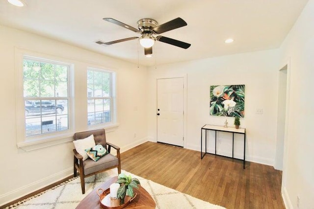 sitting room featuring ceiling fan and dark hardwood / wood-style flooring