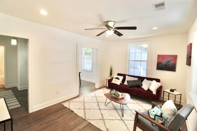 living room featuring dark hardwood / wood-style flooring and ceiling fan